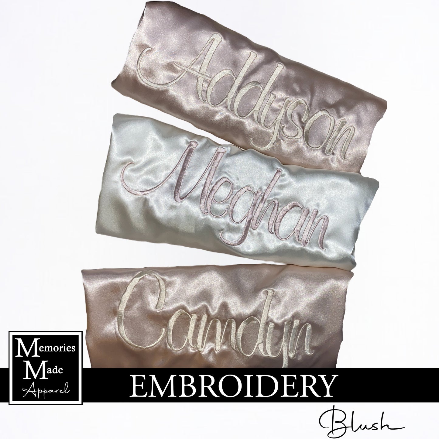 Three robes with custom embroidered names across the back. Two robes are blush, one robe is white. The robes are folded and displayed on a white background. The logo for Memories Made Apparel is in the lower left corner. The word blush is in the lower right hand corner. A banner with the word embroidery is across the bottom of the picture. 