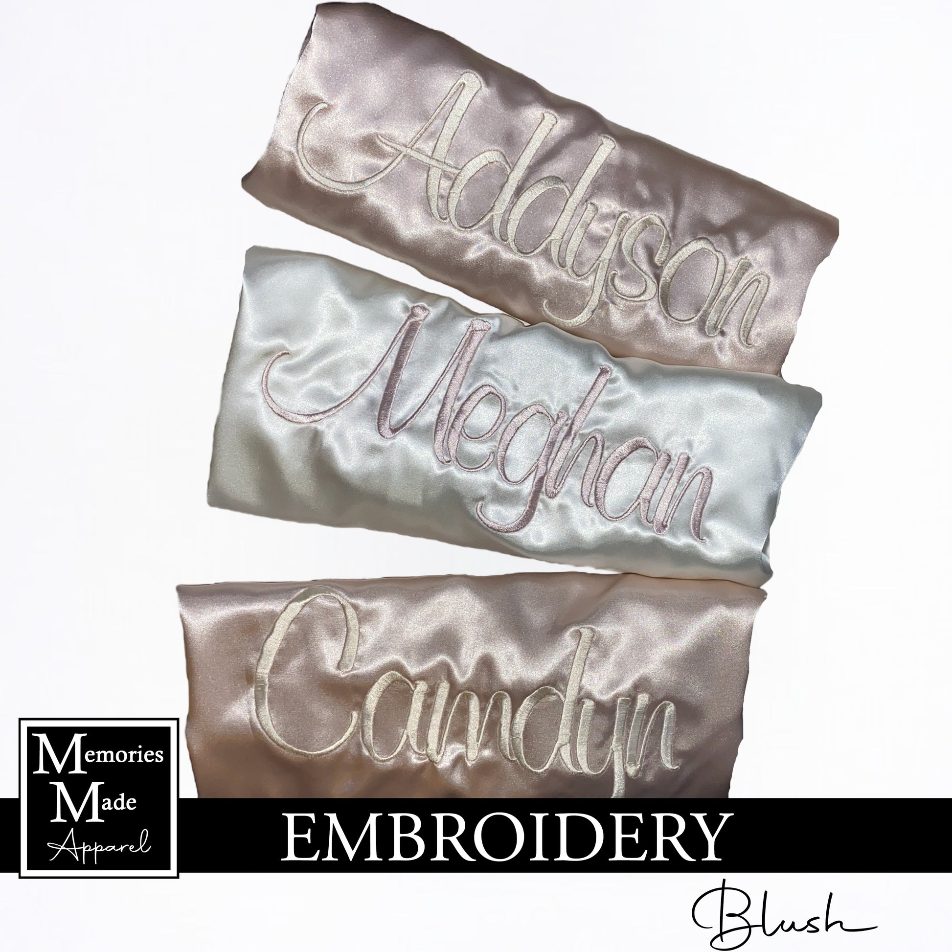 Three robes with custom embroidered names across the back. Two robes are blush, one robe is white. The robes are folded and displayed on a white background. The logo for Memories Made Apparel is in the lower left corner. The word blush is in the lower right hand corner. A banner with the word embroidery is across the bottom of the picture. 