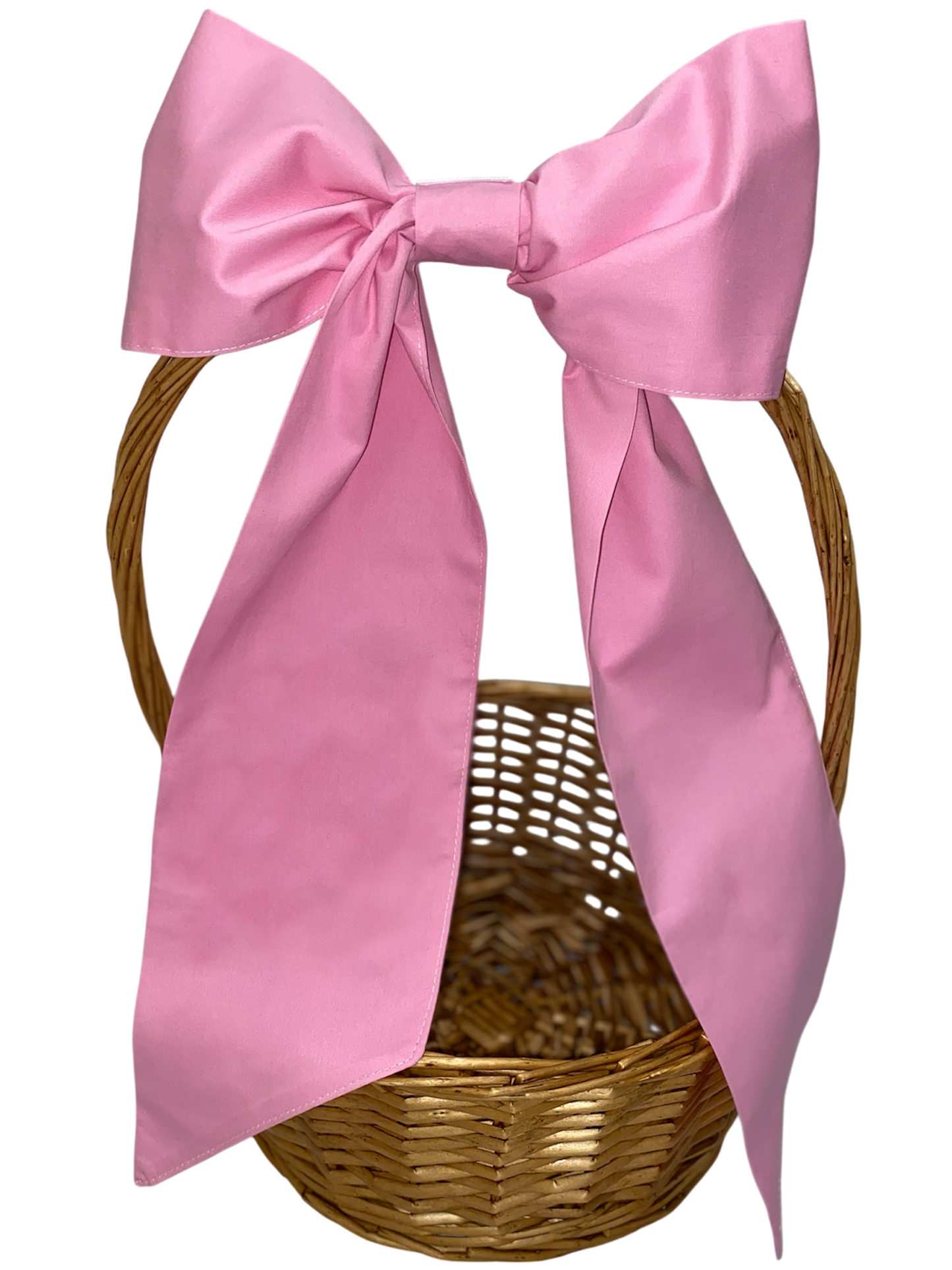 Wicker basket with a large pink bow on a white background