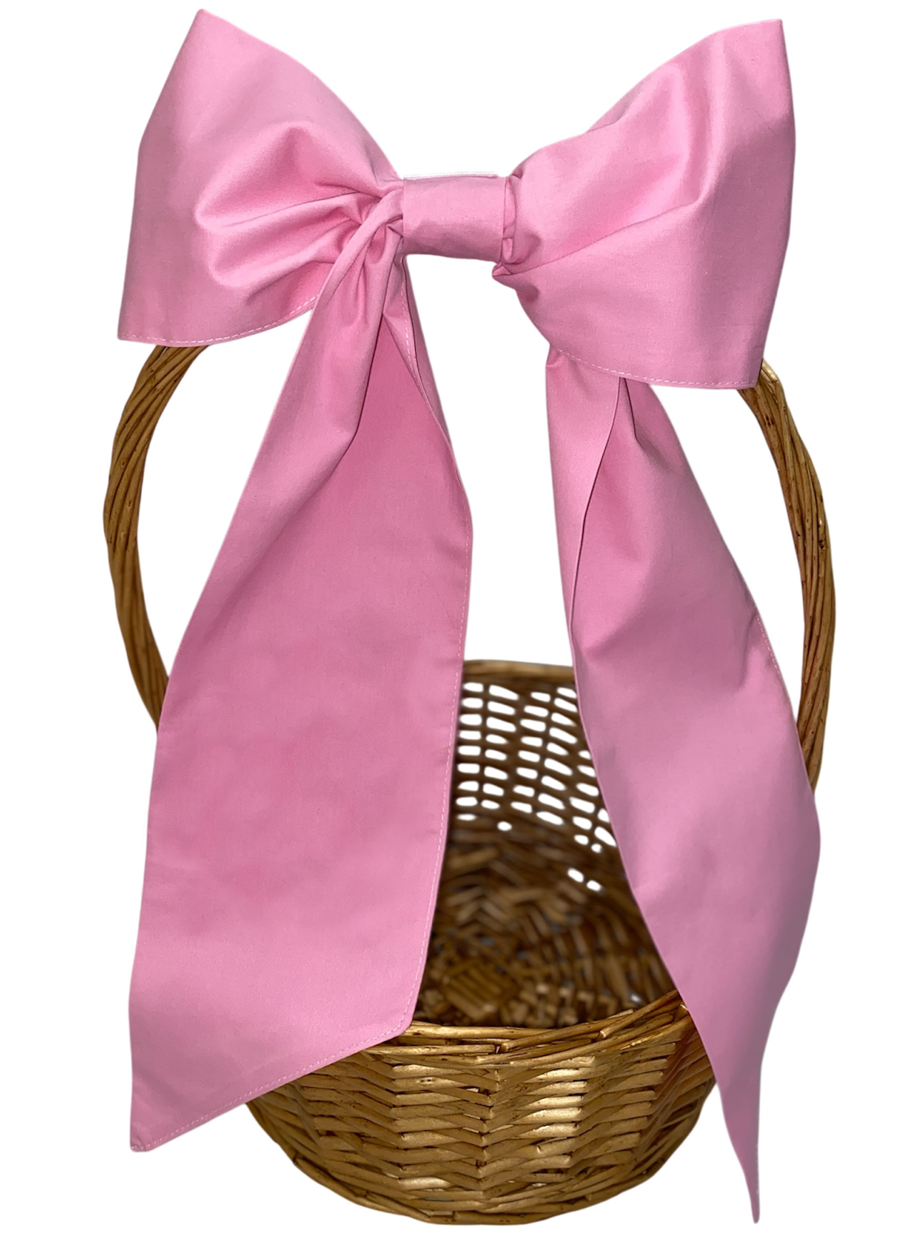 Wicker basket with a large pink bow on a white background